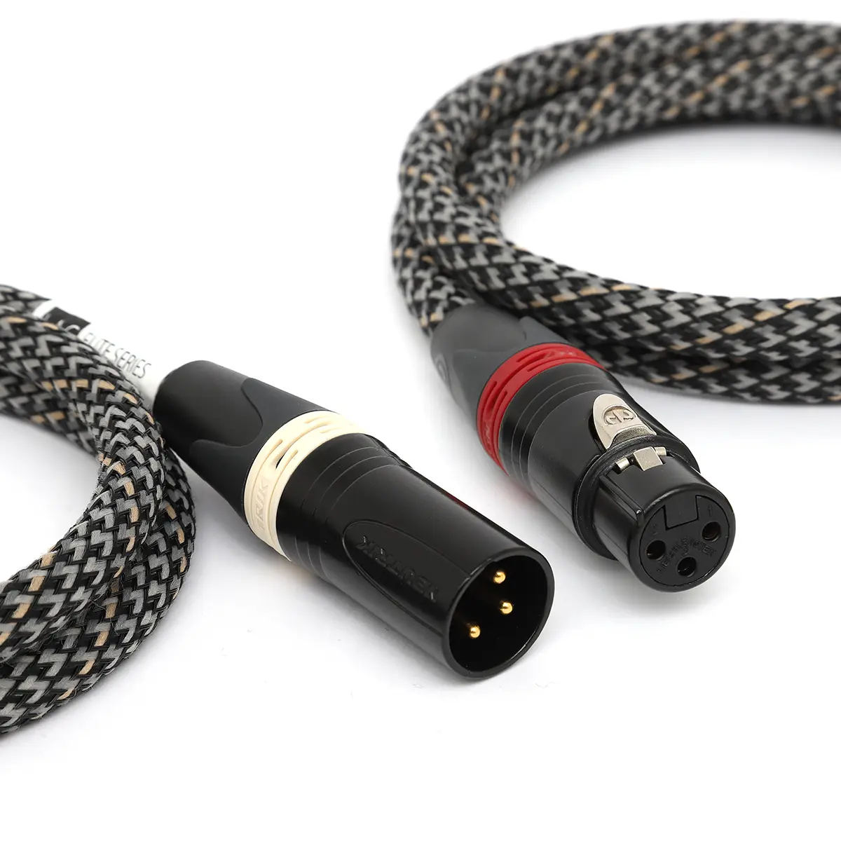 Close-up of a braided black/gray audio cable with two XLR connectors on each end, one with a cream band and the other with a red ring